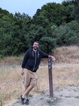 Osama Khalid, pictured at a trail marker - at intersection of Bay Area Peak and Ridge Trails - submitted