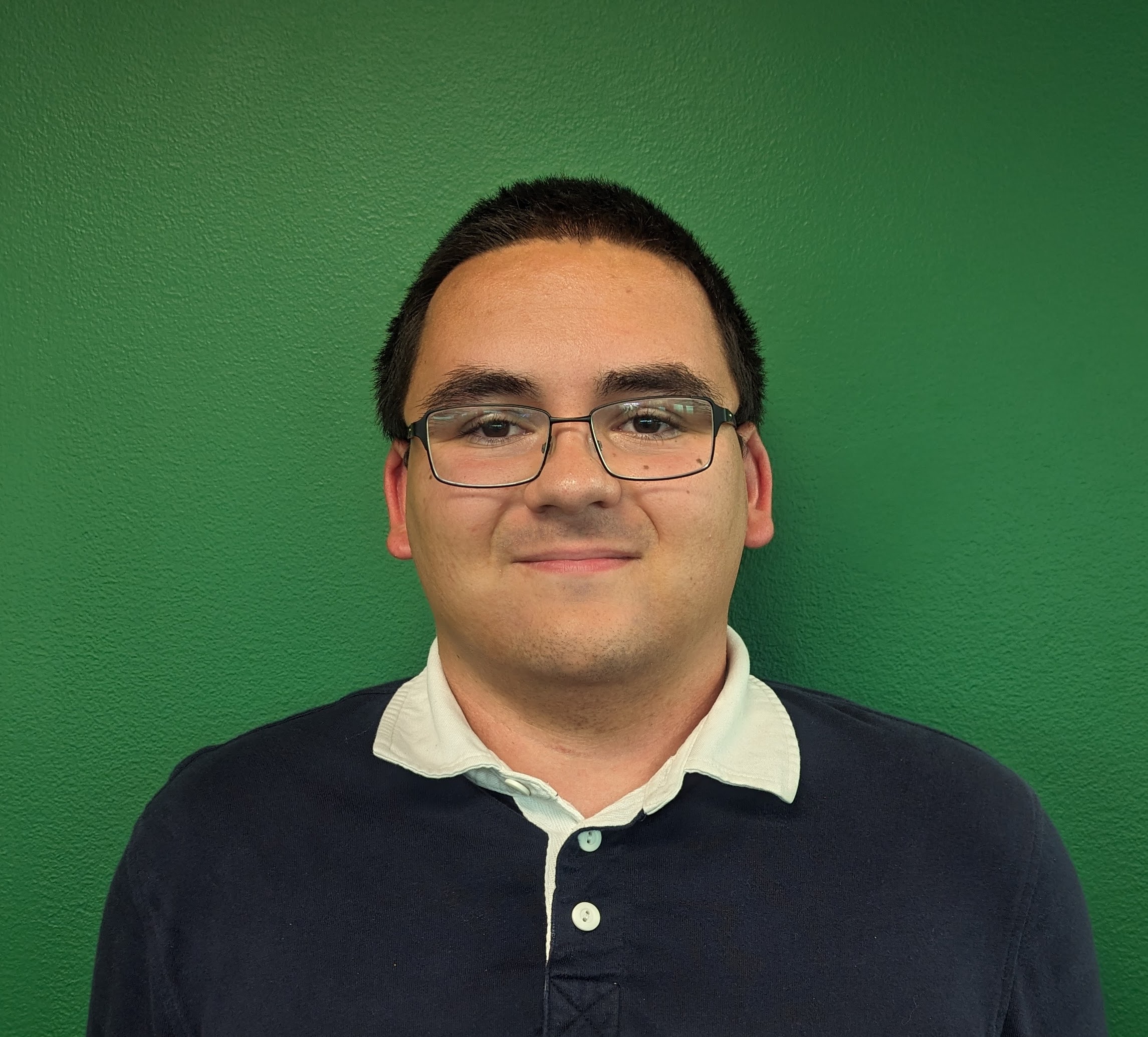 Nathan Jankowski standing in front of a solid green background