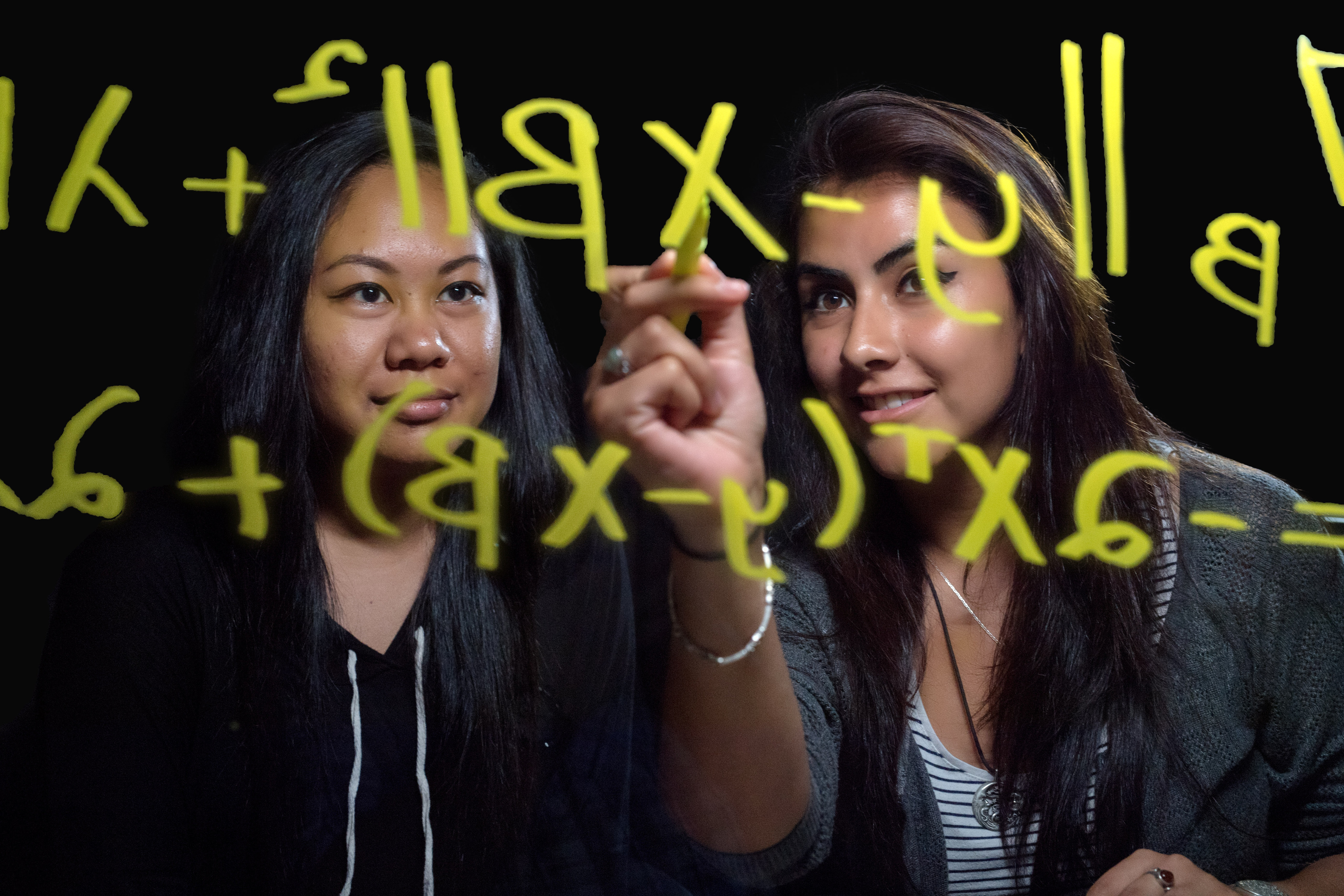 Students writing on a board