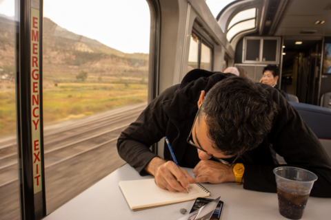 Hussam sketching on the Amtrak