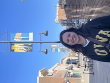 Informatics Student Meredith Onions outdoors underneath a street light with a banner featuring her photo