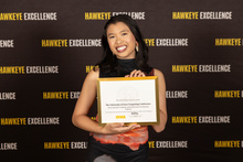 Chloe Ladines holding an award certificate
