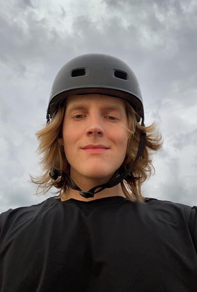 Alex Barloon portrait - with skateboard helmet on a cloudy day - submitted