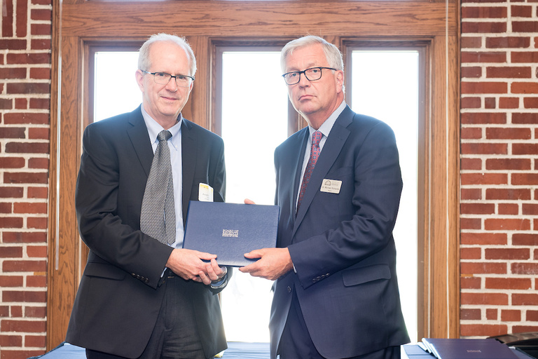 Prof. Kearney receiving award from Board of Regents President Michael Richards