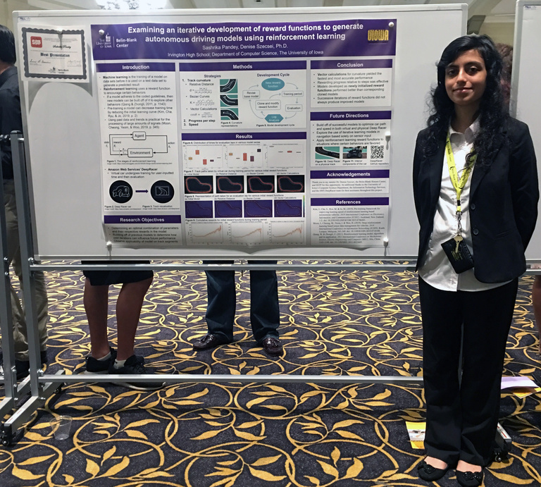 Pandey posing in front of her SSTP 2019 poster