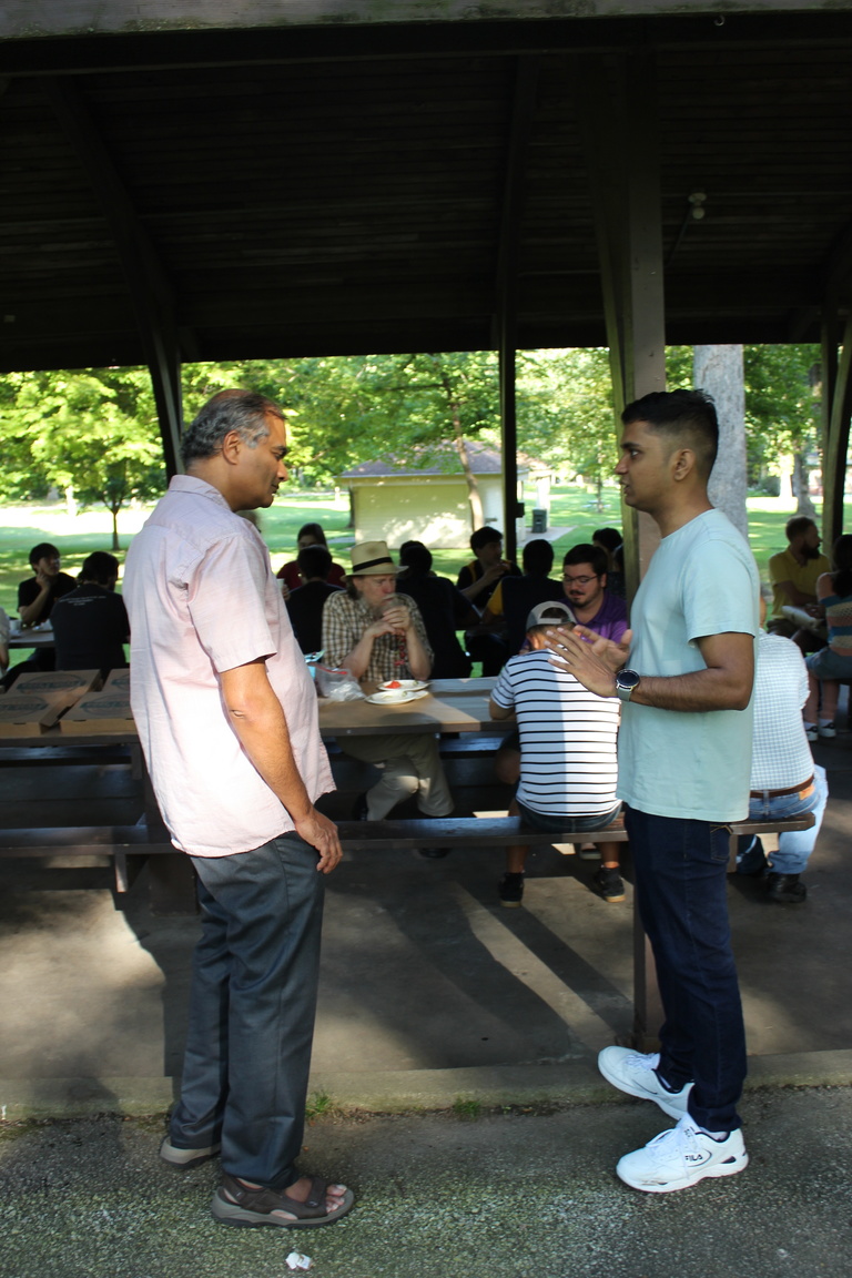 Prof. and Dir. of Grad Studies speaks with MCS student Nikhil Singh at 2022 Welcome Picnic at Iowa City City Park on August 26