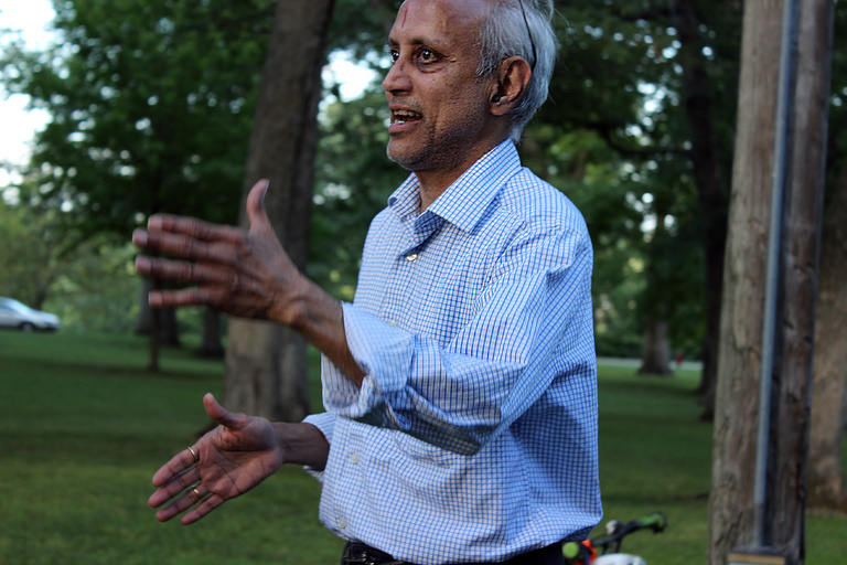 Raman Aravamudhan Adjunct Associate Professor of Instruction talking to out of frame picnic attendee