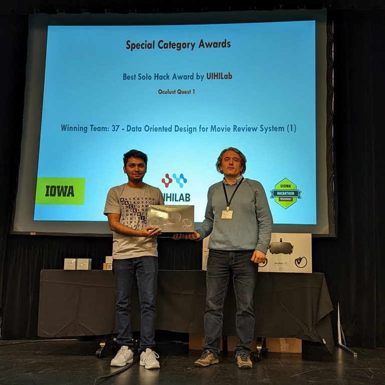 Prof. Demir Presenting Nikhil Singh his HackUIowa '22 prize