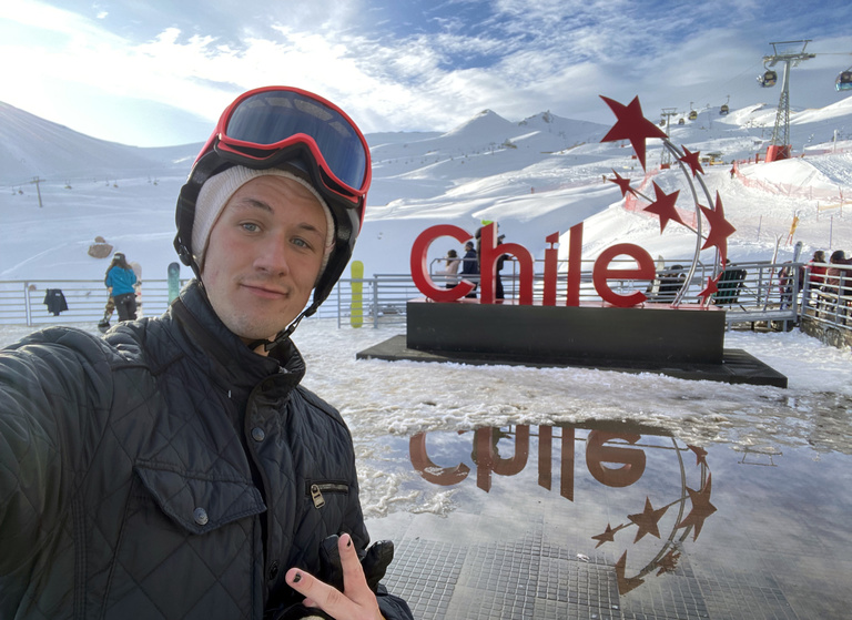 Submitted picture of David Roth dressed in winter gear at the bottom of a ski slope in Chile during Summer 2023.