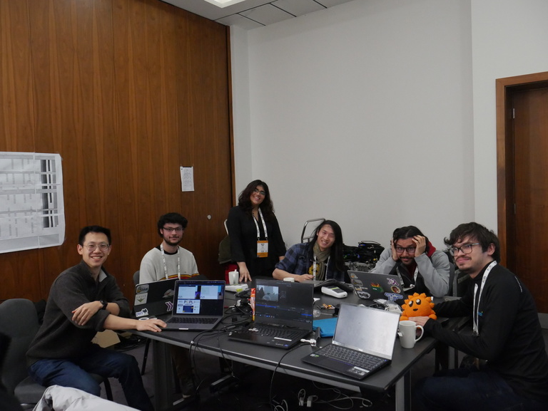 Ingle (second from right) poses with the other members of the POPL 2024 AV Committee (ft. the team’s emotional support plushie, Ferris the crab, the unofficial mascot for the Rust programming language).