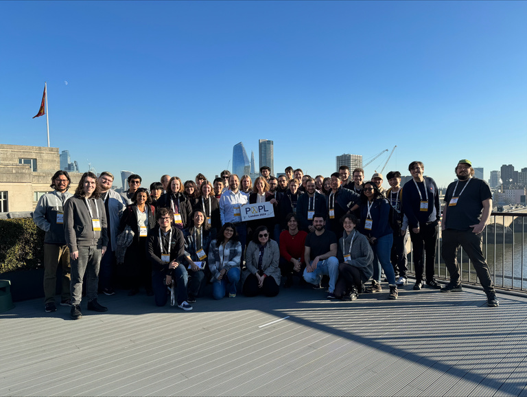 There was not a cloud in the London sky when all the volunteers for POPL 2024 gathered to take a group photo on the rooftop of the conference venue.