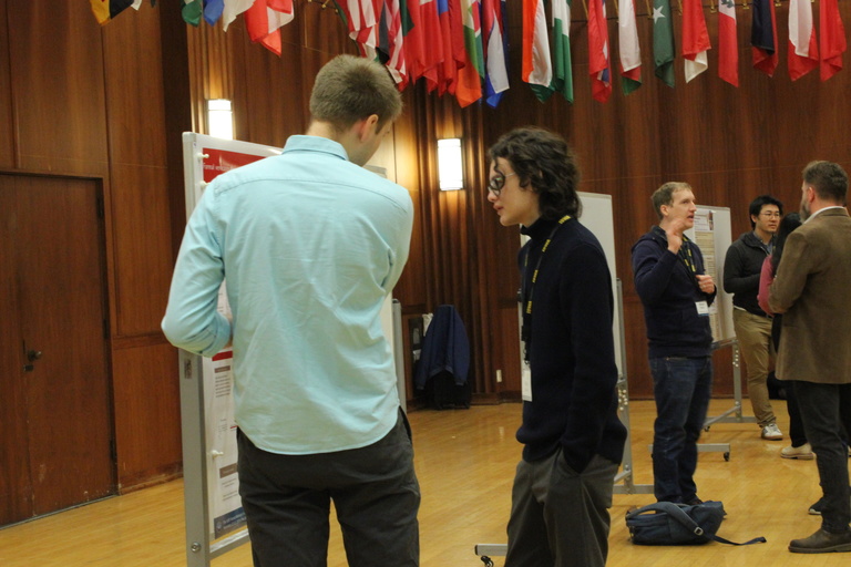 Sage Binder talks with Noah Bertram during the poster session