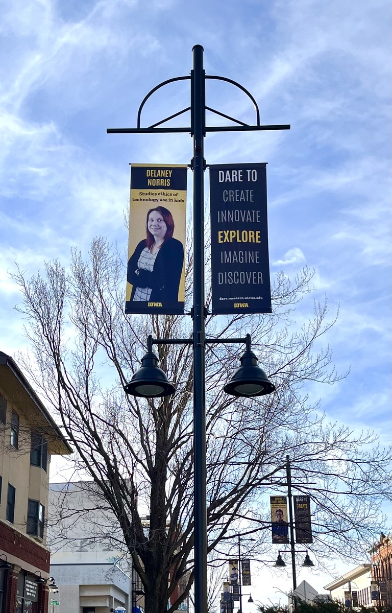 Delaney Norris' Dare to Discover banner hanging downtown in Iowa City. 