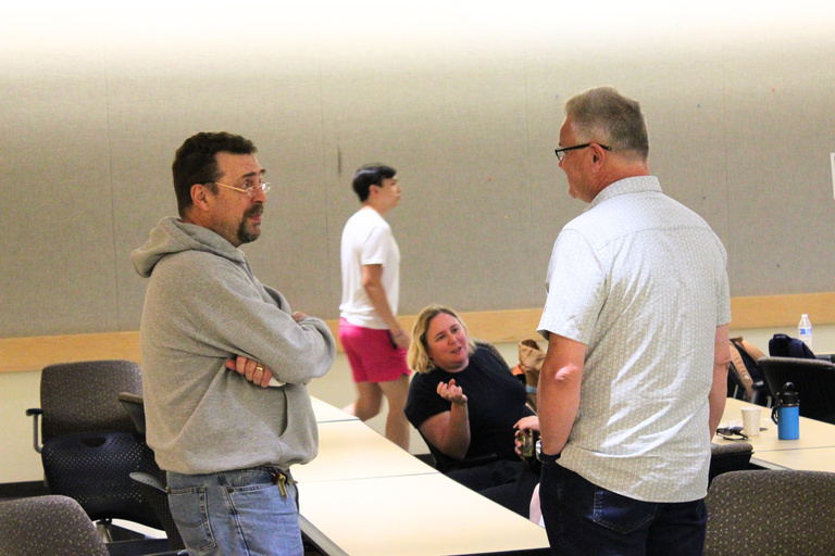 Professors chatting during the Symposium