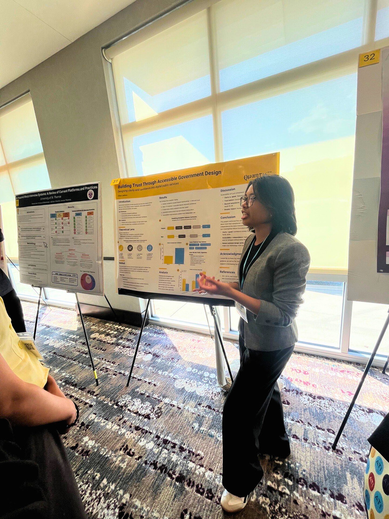Chloe Ladines presenting research poster at MINK WIC