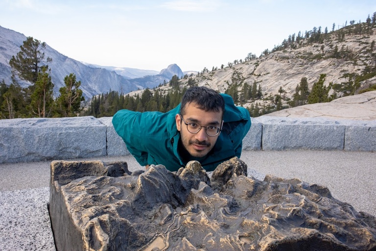 Hussam by the model of Half Dome with the actual Half Dome in the background