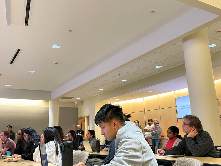 Students listening to grad symposium
