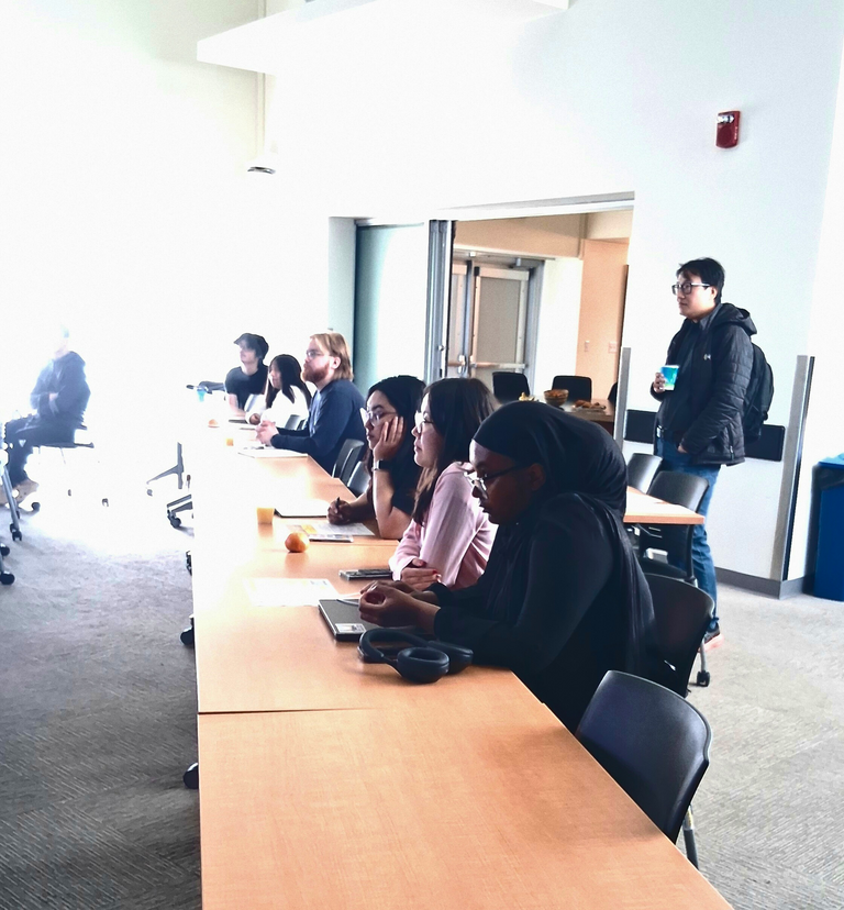 Grad Symposium students listening on presentation