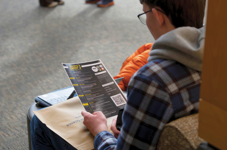 UICC 2026 attendee looking at schedule