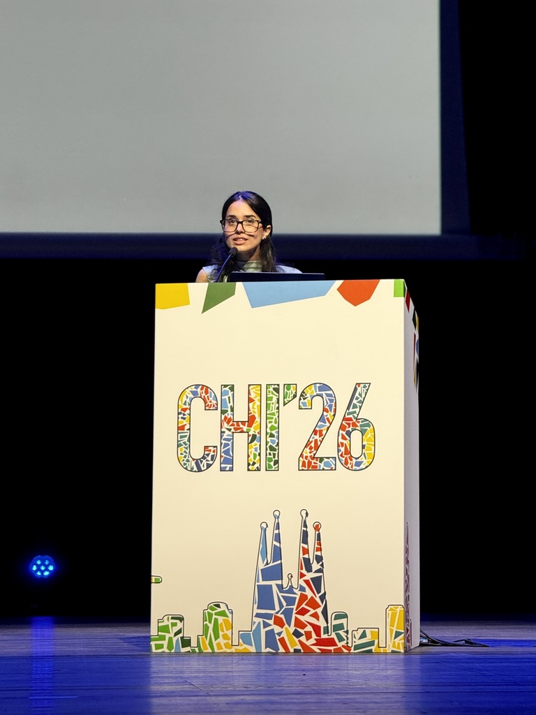 Ushna Malik at podium presenting at CHI 2026