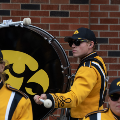 Tyler Kennedy playing drums in Hawkeye marching band