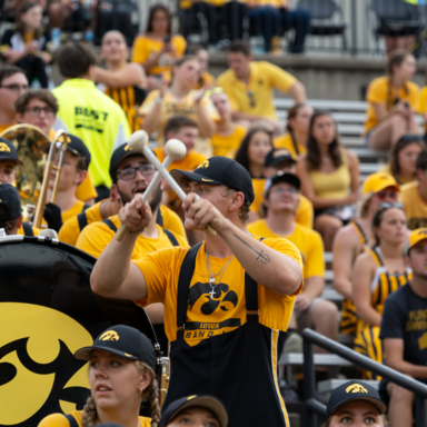 Tyler Kennedy playing drums in marching band action shot