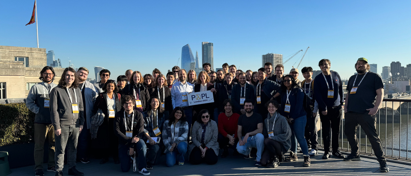 There was not a cloud in the London sky when all the volunteers for POPL 2024 gathered to take a group photo on the rooftop of the conference venue.