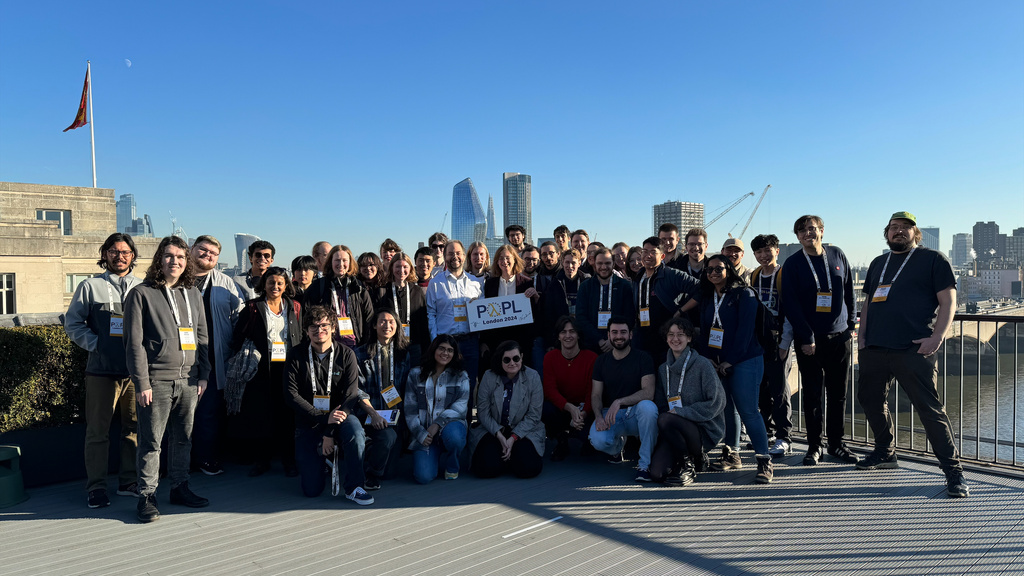 There was not a cloud in the London sky when all the volunteers for POPL 2024 gathered to take a group photo on the rooftop of the conference venue.