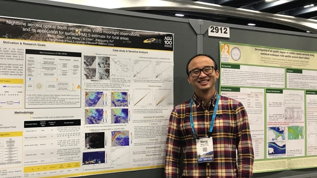 Zhou in front of his first poster presentation as a PhD student in 2019