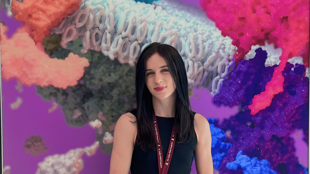 Liz Elias standing in front of a sign that says "Structural Biology"