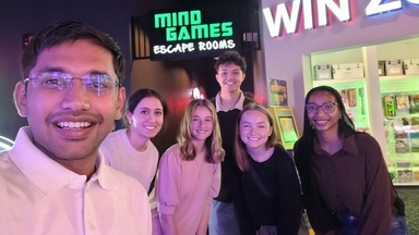 Nahar taking a selfie with the other CRST interns at an escape room